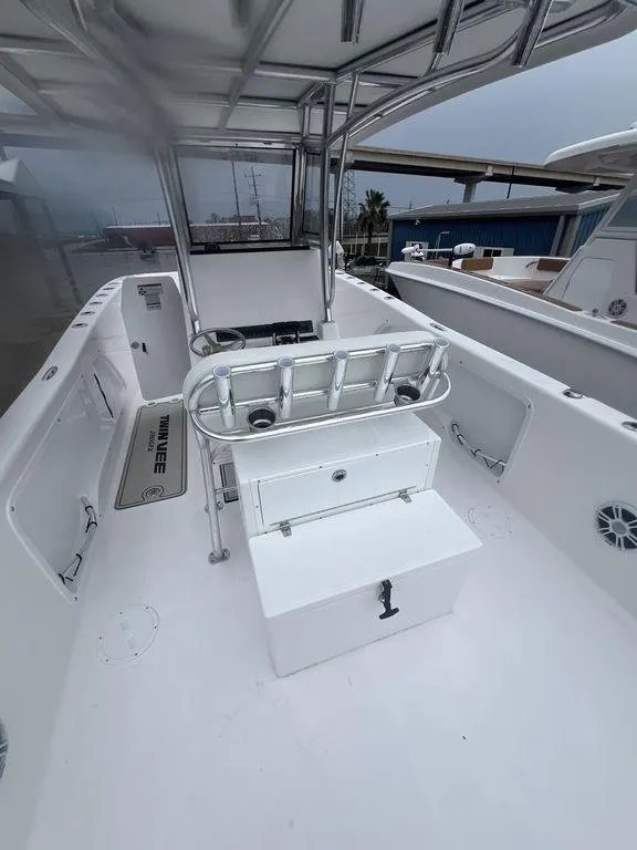 Slide: The Image of 2024 Twin Vee 280 STX boat interior with seating and storage features. - 8