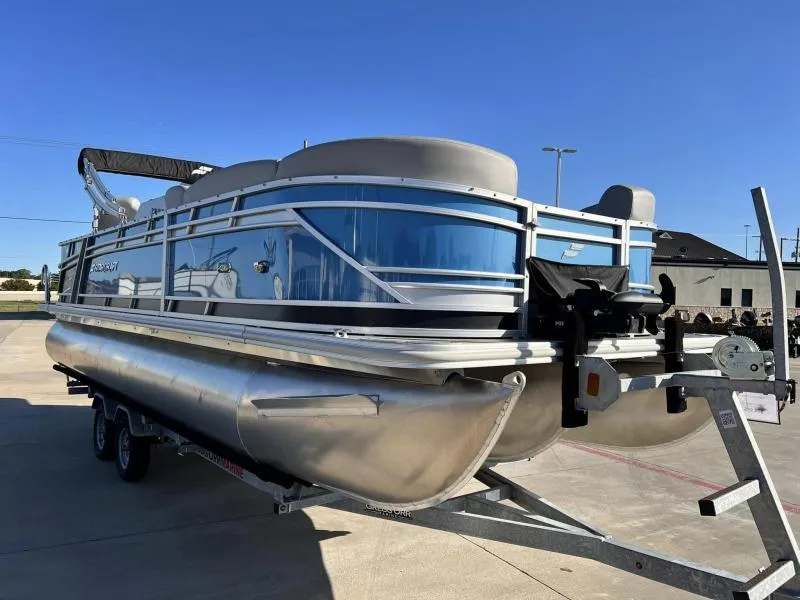 Slide: The Image of 2023 Starcraft CX 23 FD pontoon boat on a trailer in a parking lot. - 1
