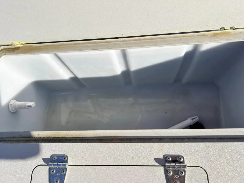 Slide: The Image of Storage compartment of 2023 Starcraft CX 23 FD boat with white interior. - 10