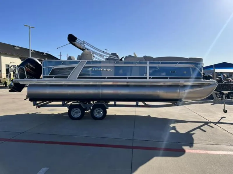 Slide: The Image of 2023 Starcraft CX 23 FD pontoon boat on trailer in outdoor lot. - 2
