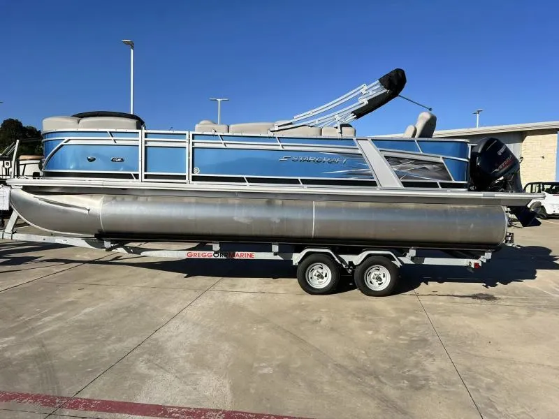 Slide: The Image of 2023 Starcraft CX 23 FD pontoon boat on a trailer in a parking lot. - 5