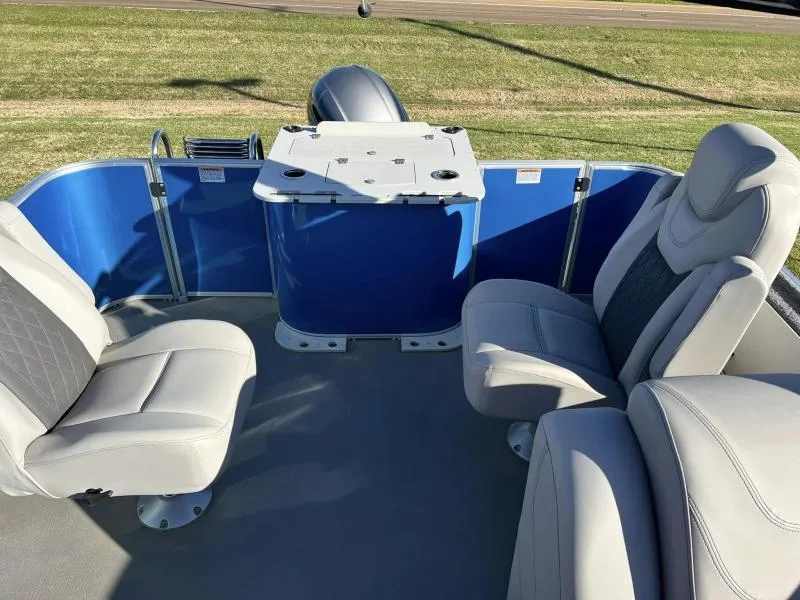 Slide: The Image of 2023 Starcraft CX 23 FD boat interior with comfortable seating and blue paneling. - 8