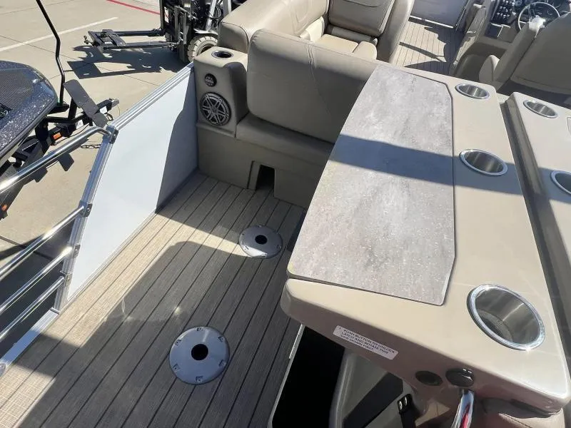 Slide: The Image of Interior of 2023 Starcraft CX 25 DL BAR boat with seating and cup holders. - 11