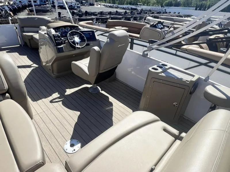 Slide: The Image of 2023 Starcraft CX 25 DL BAR boat interior with helm, seating, and storage. - 12