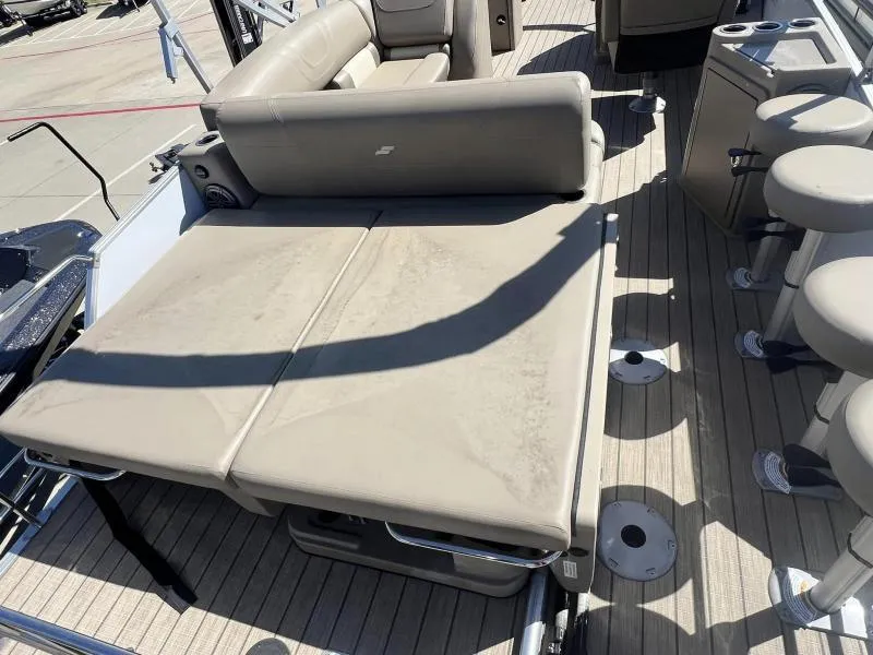 Slide: The Image of 2023 Starcraft CX 25 DL BAR boat interior with beige seating and bar stools. - 13