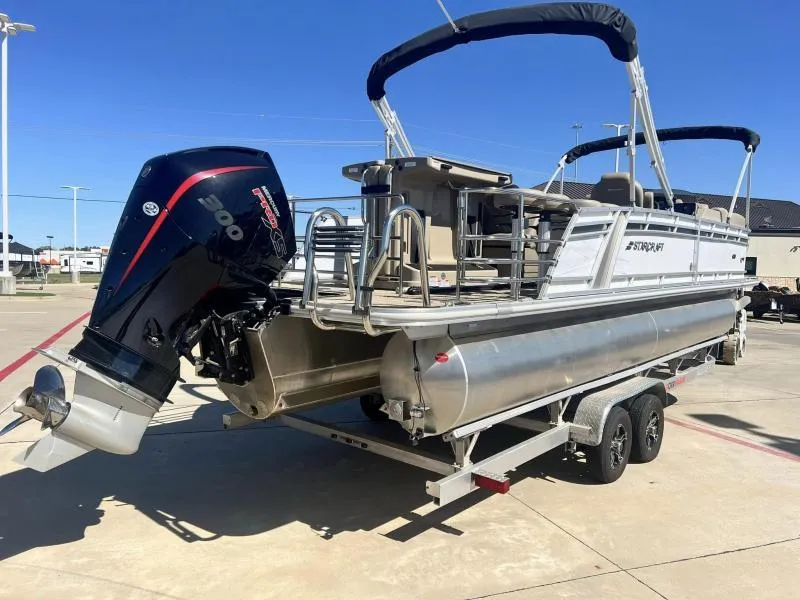 Slide: The Image of 2023 Starcraft CX 25 DL BAR pontoon boat on trailer with 300 horsepower outboard motor. - 4