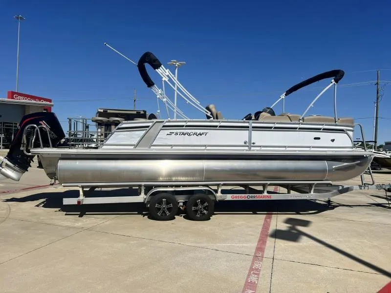 Slide: The Image of 2023 Starcraft CX 25 DL BAR pontoon boat on a trailer at a dealership. - 5