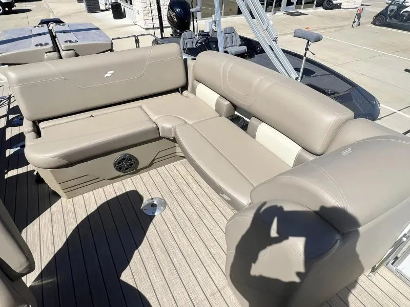 Slide: The Image of 2023 Starcraft CX 25 DL BAR boat with beige seating and wood flooring. - 9