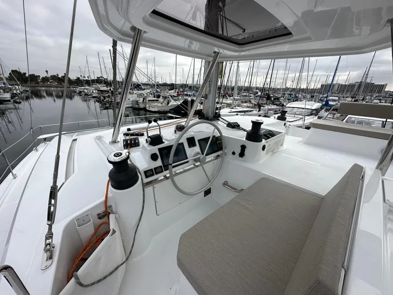 Slide: The Image of 2024 Bali 4.4 yacht helm station with marina background. - 18