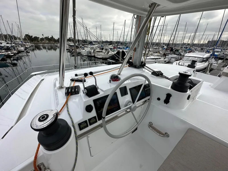Slide: The Image of Helm station of 2024 Bali 4.4 yacht docked at marina with sailboats. - 19