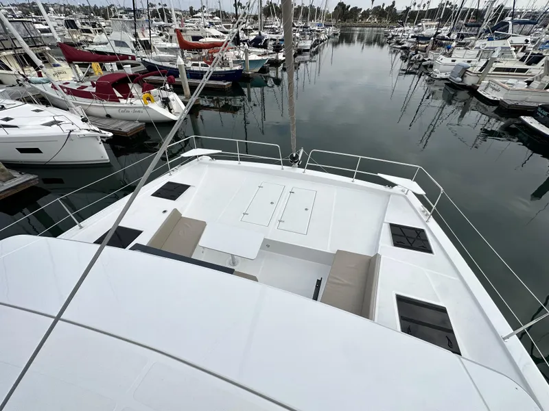 Slide: The Image of 2024 Bali 4.4 catamaran docked at a marina with multiple boats. - 24