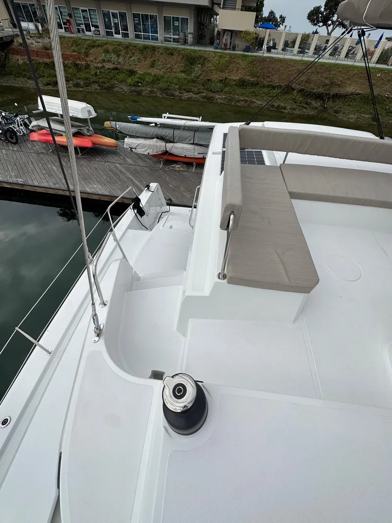 Slide: The Image of 2024 Bali 4.4 yacht deck with seating area and dock view. - 25