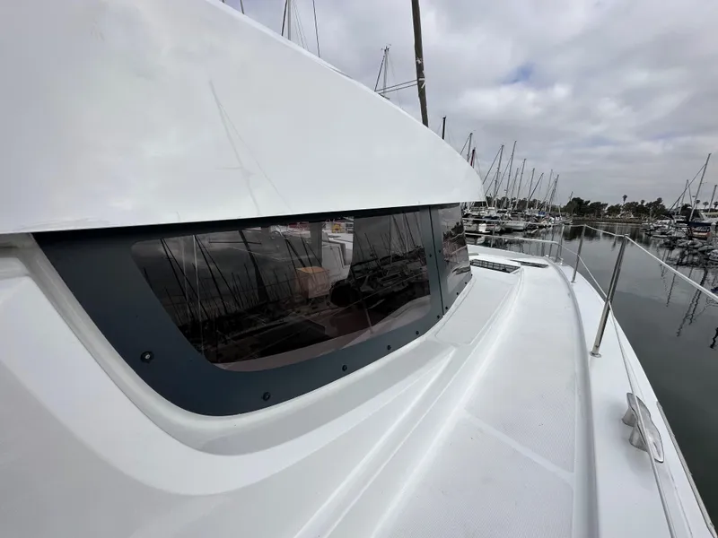 Slide: The Image of 2024 Bali 4.4 yacht docked at a marina with overcast skies. - 28