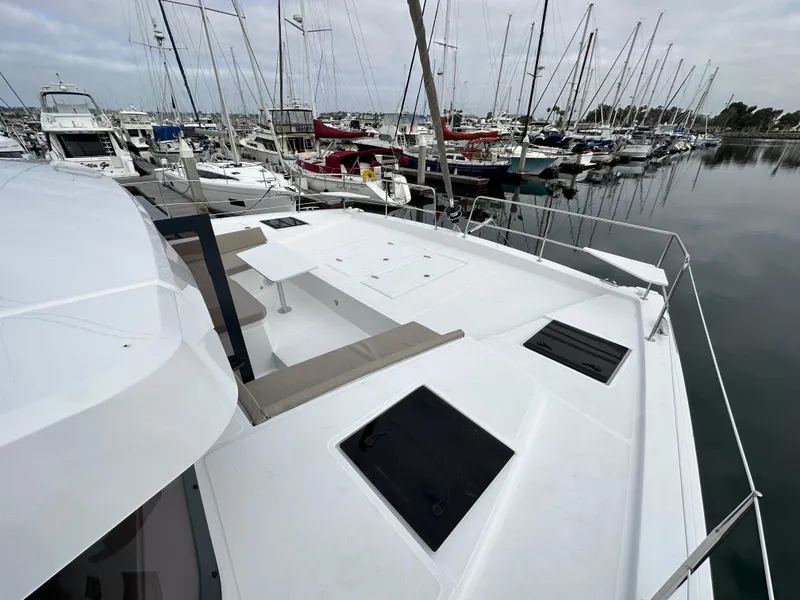Slide: The Image of 2024 Bali 4.4 yacht docked at a marina with other boats. - 29