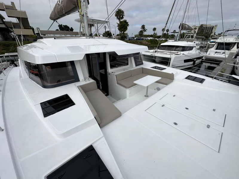 Slide: The Image of 2024 Bali 4.4 catamaran with spacious deck and seating area docked at marina. - 30