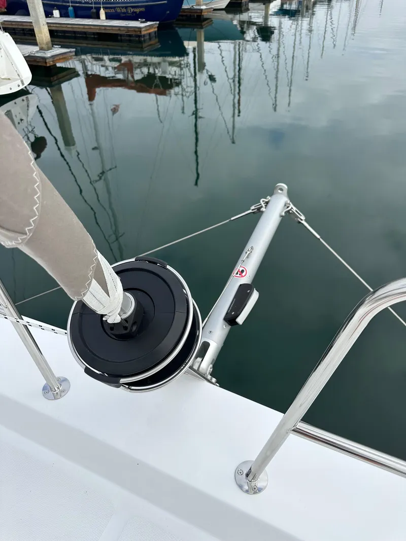 Slide: The Image of 2024 Bali 4.4 sailboat docked, showing rigging and winch system. - 33