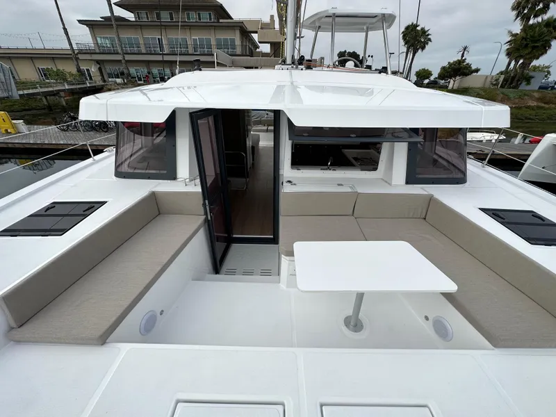 Slide: The Image of 2024 Bali 4.4 yacht with spacious outdoor seating and table. - 34