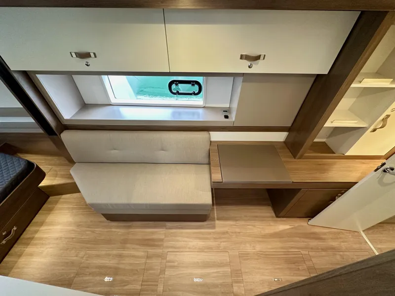 Slide: The Image of 2024 Bali 4.4 interior with beige sofa, wooden flooring, and storage cabinets. - 48