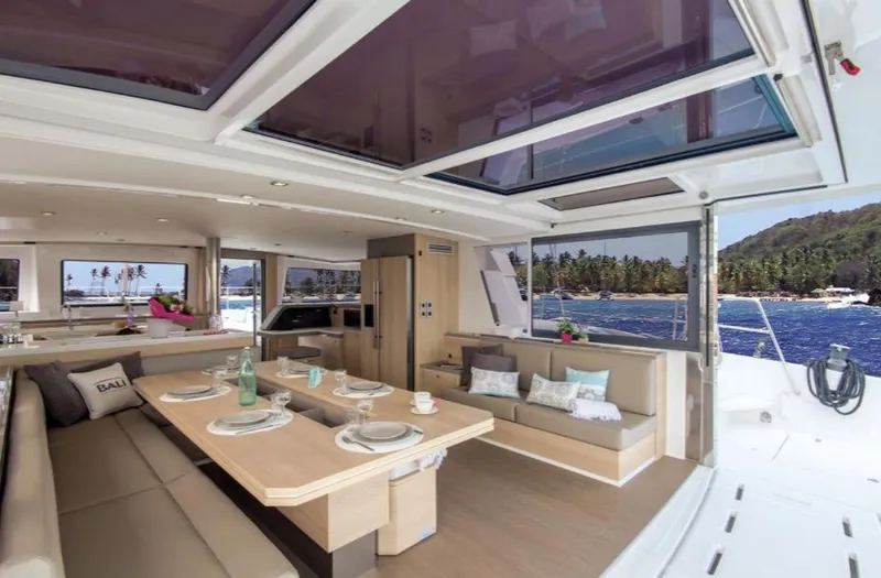 Slide: The Image of Luxurious Bali 5.4 yacht interior, 2025 model, featuring spacious dining area and scenic ocean view. - 13