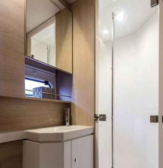 Slide: The Image of Modern bathroom interior in 2025 Bali 5.4 model yacht, featuring sleek wood cabinetry. - 25