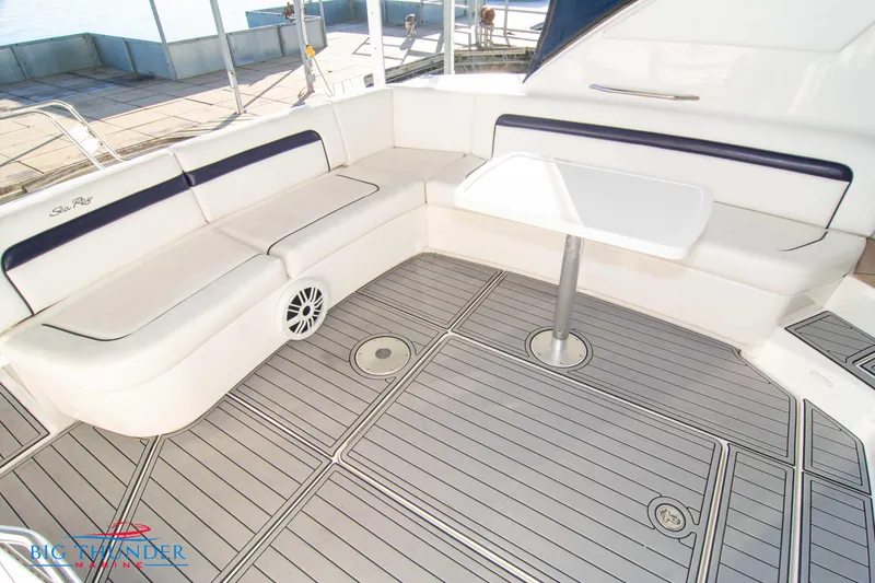 Slide: The Image of 2010 Sea Ray 540 Sundancer yacht deck with seating and table, featuring sleek design. - 12