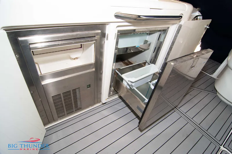 Slide: The Image of 2010 Sea Ray 540 Sundancer yacht interior with open stainless steel refrigerator and ice maker. - 18