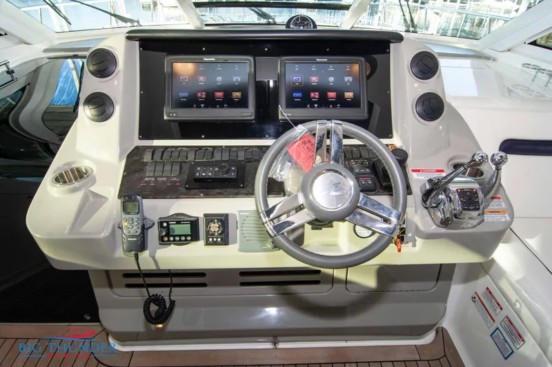 Slide: The Image of Helm of 2010 Sea Ray 540 Sundancer with dual screens and modern controls. - 29