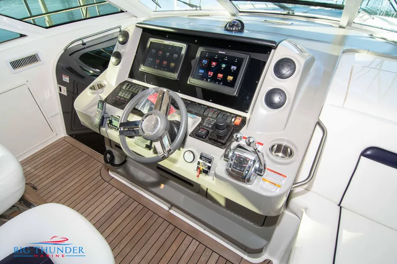 Slide: The Image of Helm of 2010 Sea Ray 540 Sundancer with advanced navigation controls and dual displays. - 30