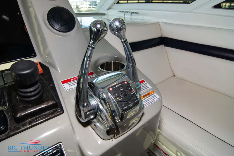 Slide: The Image of Control panel of a 2010 Sea Ray 540 Sundancer yacht with dual throttle levers. - 42