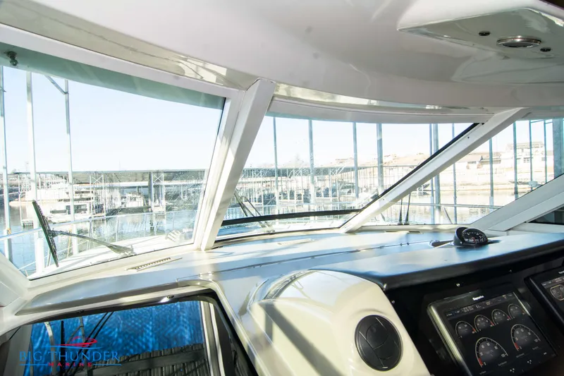 Slide: The Image of Interior view of 2010 Sea Ray 540 Sundancer yacht cockpit with marina background. - 44