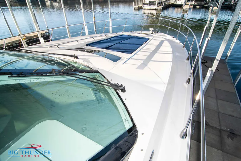 Slide: The Image of 2010 Sea Ray 540 Sundancer yacht docked, showcasing sleek design and spacious deck. - 45