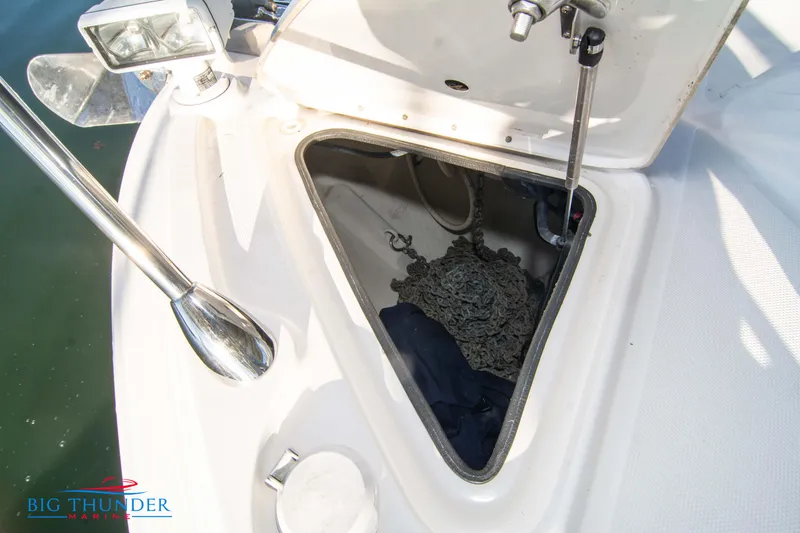 Slide: The Image of Anchor storage compartment on 2010 Sea Ray 540 Sundancer boat, featuring chain and equipment. - 49