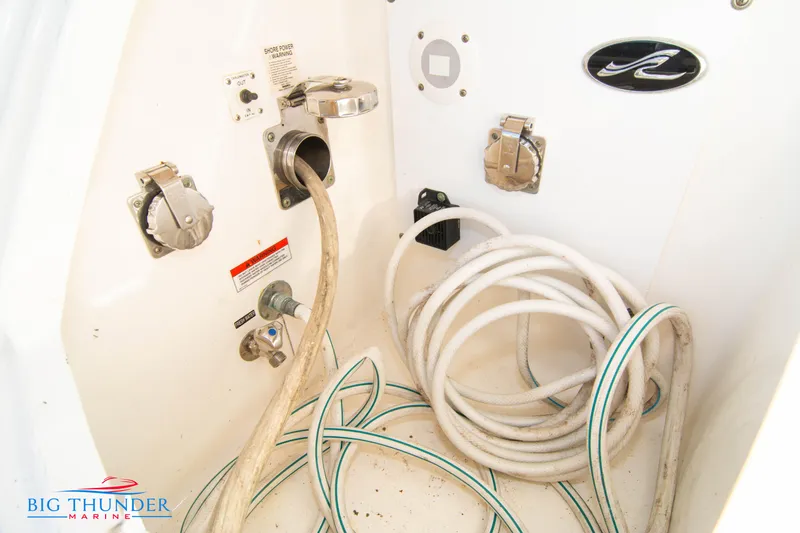 Slide: The Image of 2010 Sea Ray 540 Sundancer boat utility connections and hoses. - 7