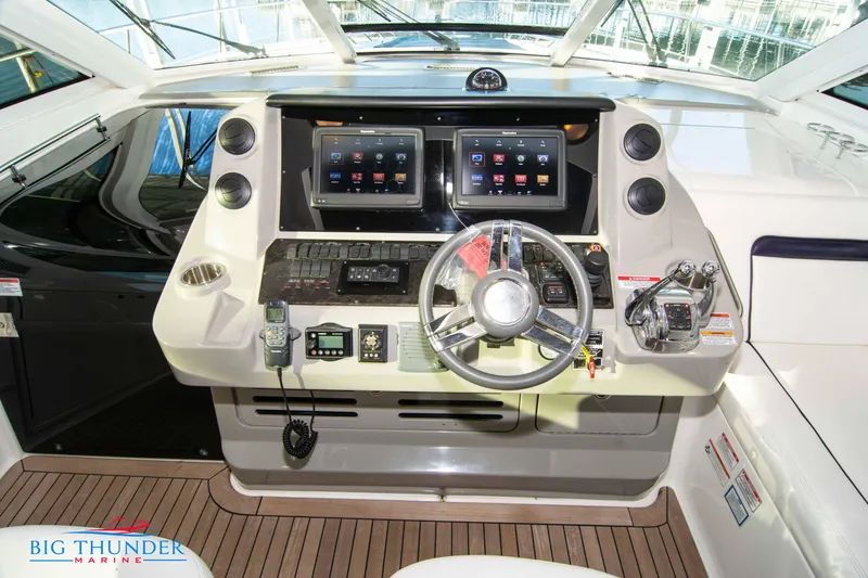 Slide: The Image of Helm of 2010 Sea Ray 540 Sundancer with advanced navigation controls and dual displays. - 28