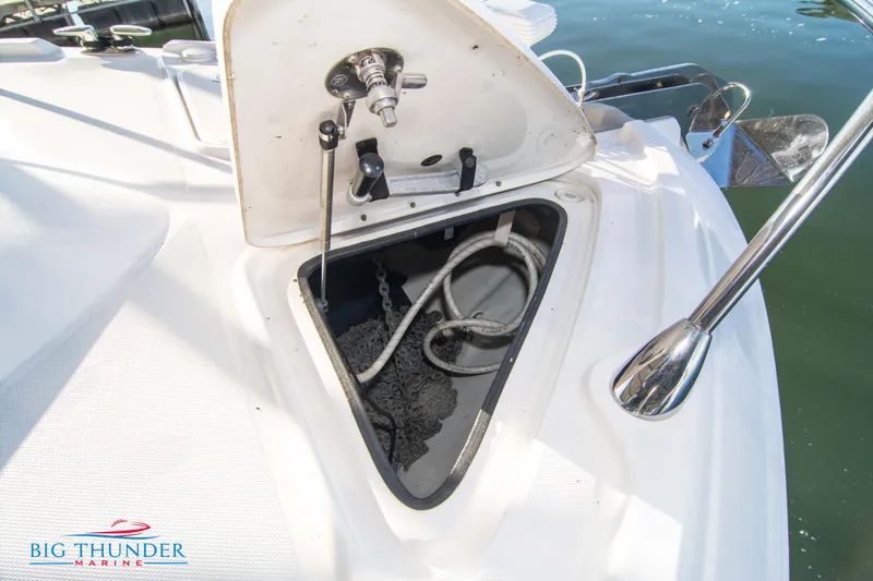 Slide: The Image of Open anchor locker on 2010 Sea Ray 540 Sundancer boat, showing chain and rope storage. - 48