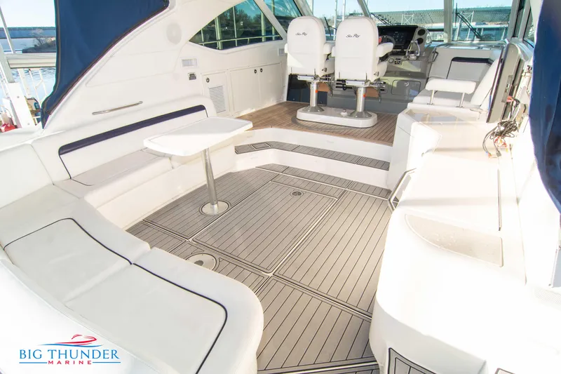 Slide: The Image of 2010 Sea Ray 540 Sundancer yacht interior with seating and helm, featuring elegant design. - 10