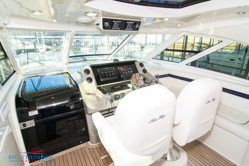 Slide: The Image of Helm of 2010 Sea Ray 540 Sundancer yacht with dual white seats and modern controls. - 26