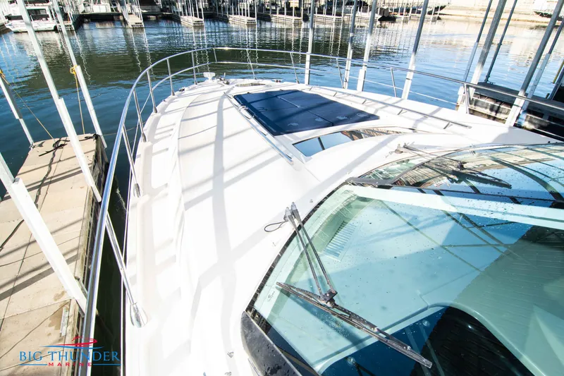 Slide: The Image of 2010 Sea Ray 540 Sundancer yacht docked at marina, showcasing sleek deck design. - 46