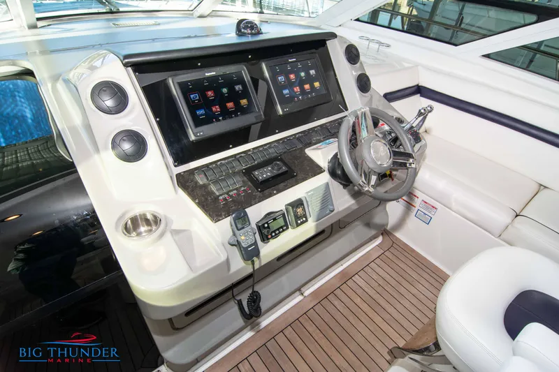 Slide: The Image of 2010 Sea Ray 540 Sundancer helm with dual displays and modern controls. - 31