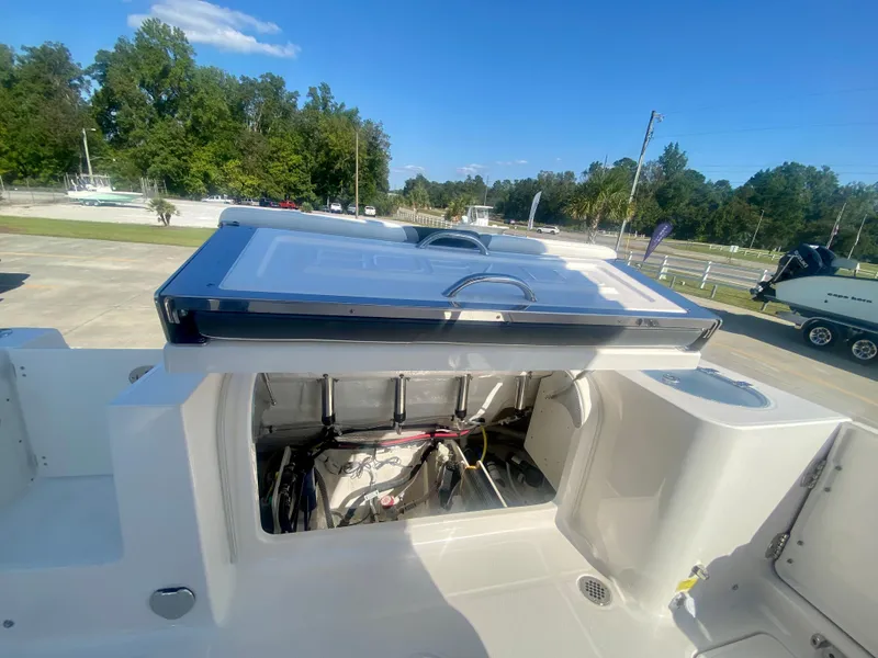 Slide: The Image of 2026 Robalo R250 boat with open engine compartment, showcasing interior mechanics. - 11