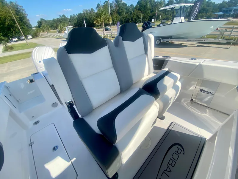 Slide: The Image of 2026 Robalo R250 boat interior with dual white and black seats. - 18