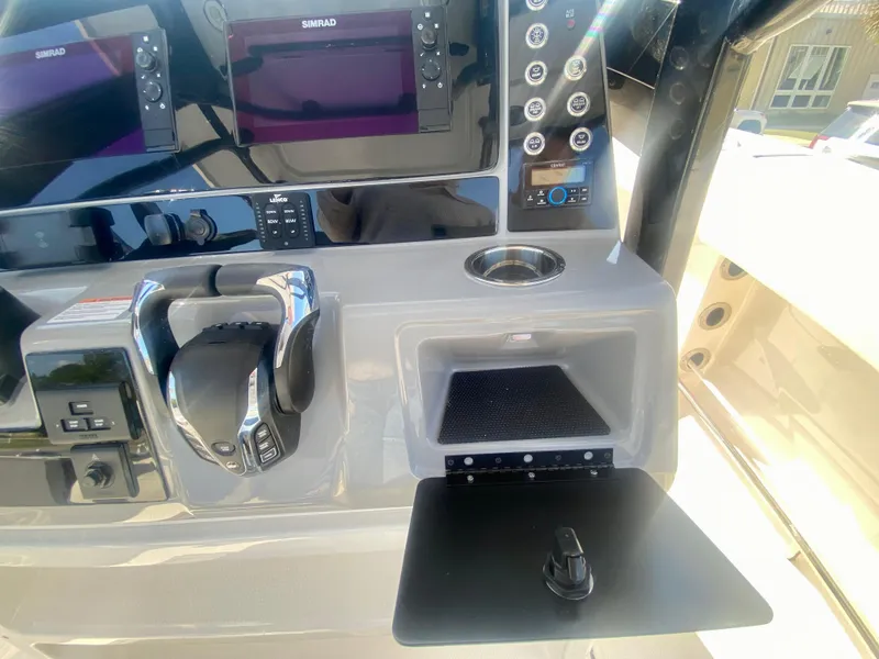 Slide: The Image of 2026 Robalo R250 boat dashboard with advanced controls and navigation displays. - 22