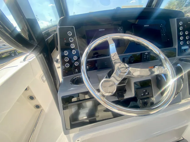 Slide: The Image of 2026 Robalo R250 boat dashboard with steering wheel and control panels. - 23