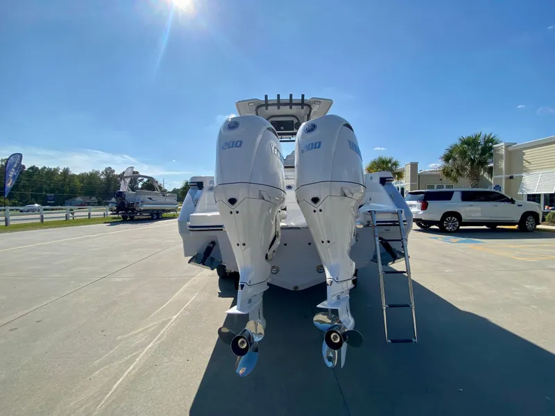 Slide: The Image of 2026 Robalo R250 boat with dual outboard engines in a sunny outdoor setting. - 4