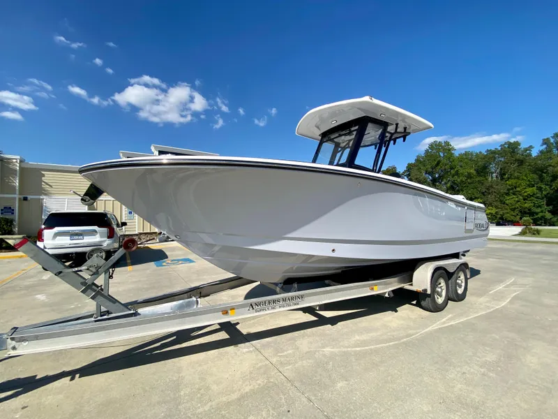 Slide: The Image of 2026 Robalo R250 boat on trailer under clear blue sky. - 6