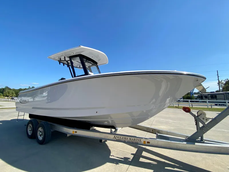 Slide: The Image of 2026 Robalo R250 boat on trailer under clear blue sky. - 3