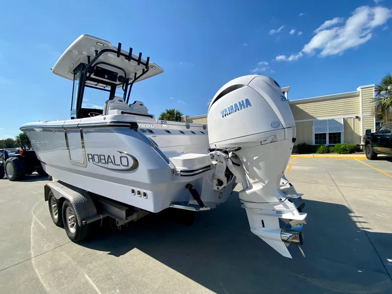 Slide: The Image of 2026 Robalo R250 boat with Yamaha engine on trailer, parked outdoors. - 5