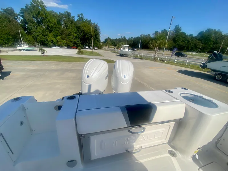 Slide: The Image of 2026 Robalo R250 boat with dual engines, parked outdoors on a sunny day. - 8