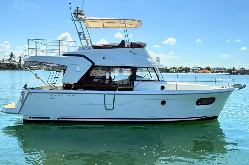 The Image of 2021 Beneteau Swift Trawler 35 on calm water, side view. - 0