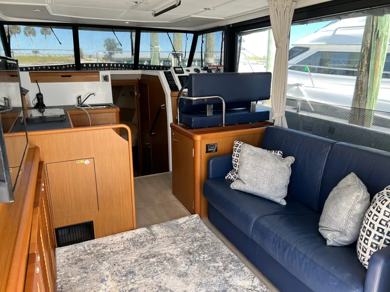 Slide: The Image of Interior of 2021 Beneteau Swift Trawler 35 with modern kitchen and cozy seating area. - 14